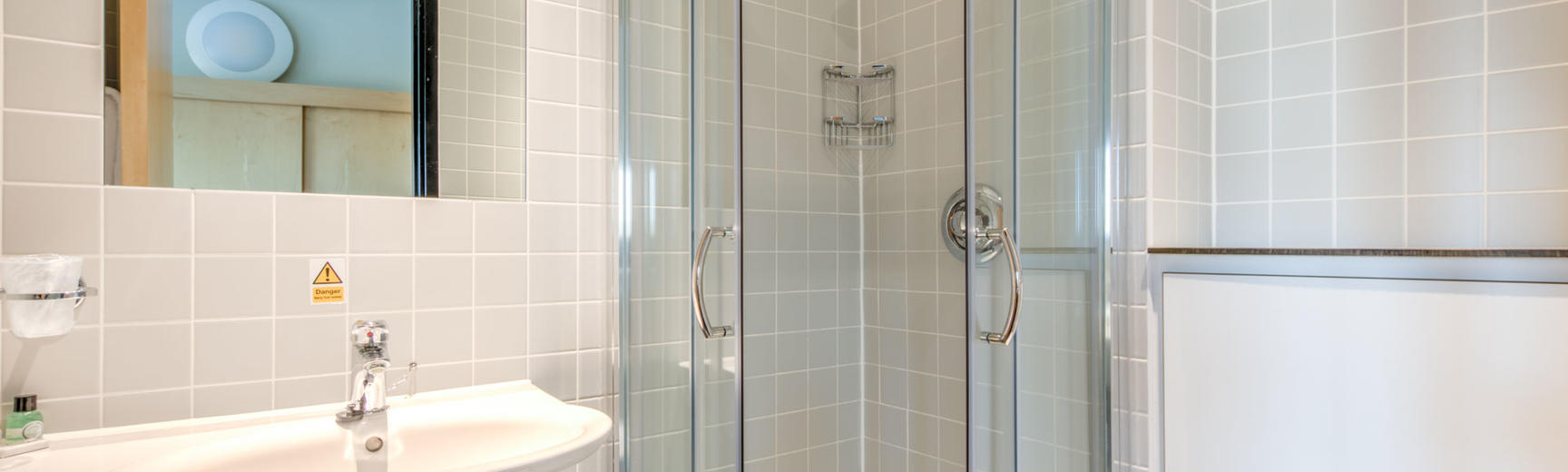 Photo of a bathroom with shower and washbasin