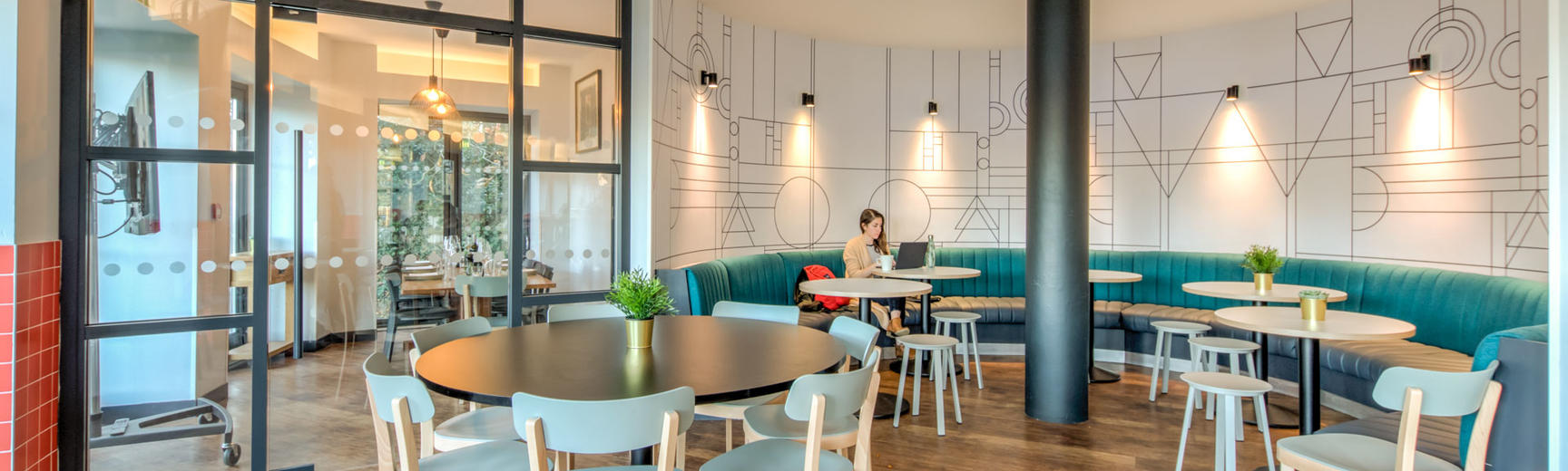 Photo of a cafe seating area with chairs around round tables