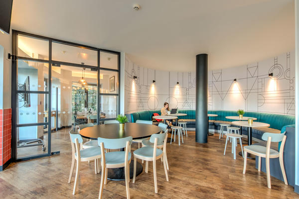 Photo of a cafe seating area with chairs around round tables