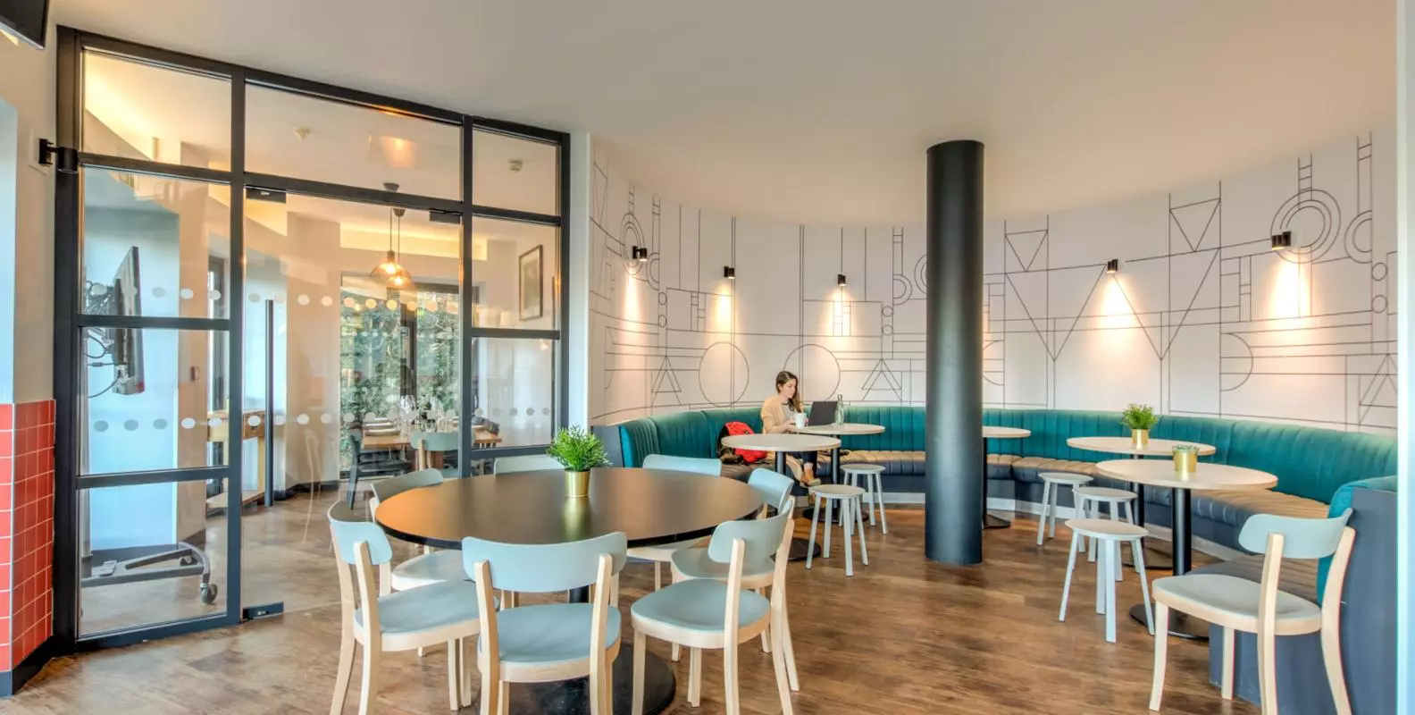 Photo of a cafe seating area with chairs around round tables